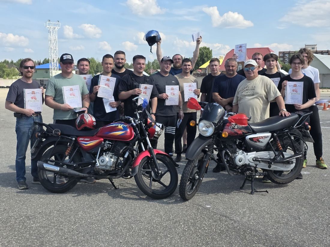 Группа выпускников категории А с грамотами у учебных мотоциклов